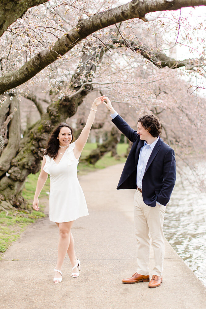 Candid engagement pictures at the Tidal Basin cherry blossoms