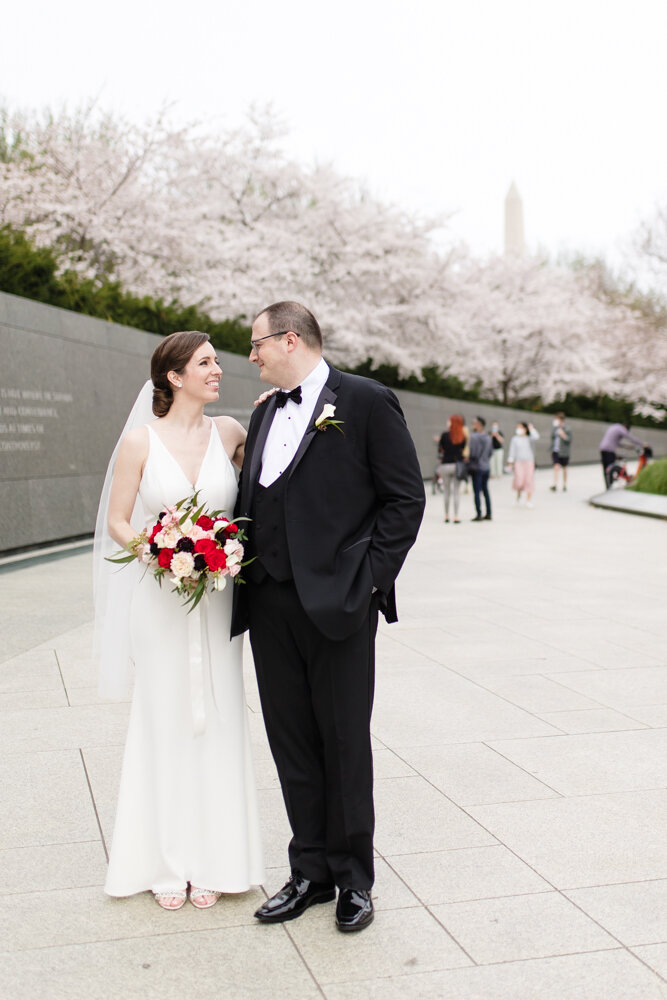 Wedding couple with cherry blossoms at the MLK Memorial