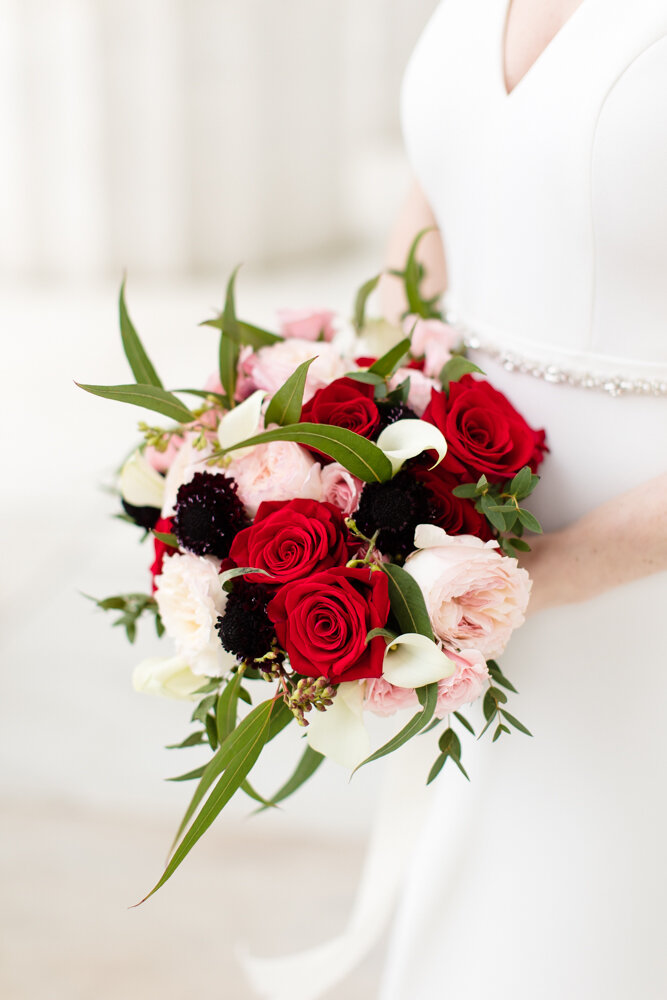 Colorful wedding bouquet with red, pink, and white