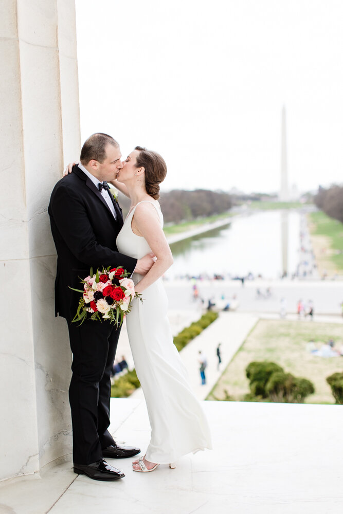 Wedding photo in the Lincoln Memorial with view of the Reflecting Pool and Washington Monument