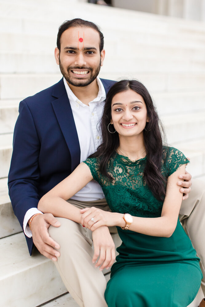 Indian engaged couple sitting on the steps of the Lincoln Memorial