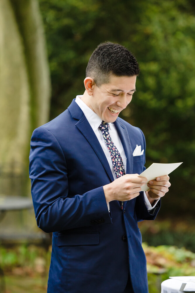Groom reading a letter during his elopement ceremony