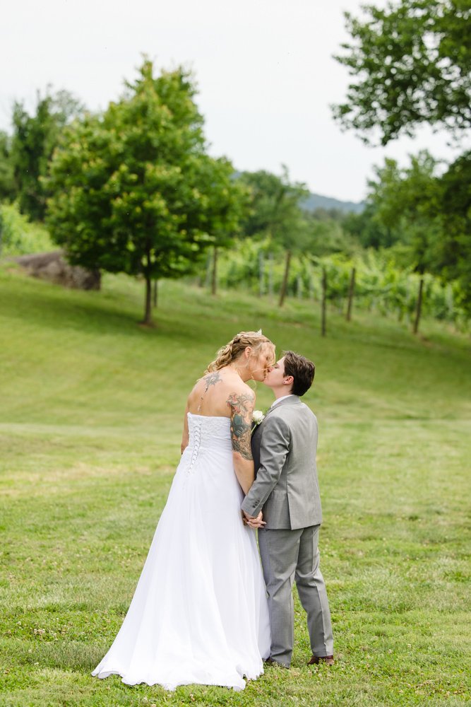 Brides kissing at Naked Mountain Winery
