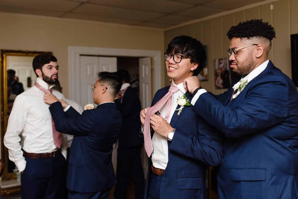 Groom getting ready for the wedding day with his groomsmen