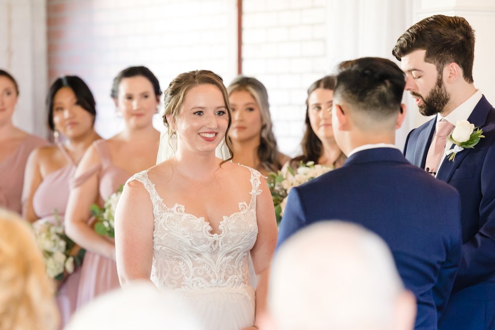 Bride smiling at groom during the ceremony