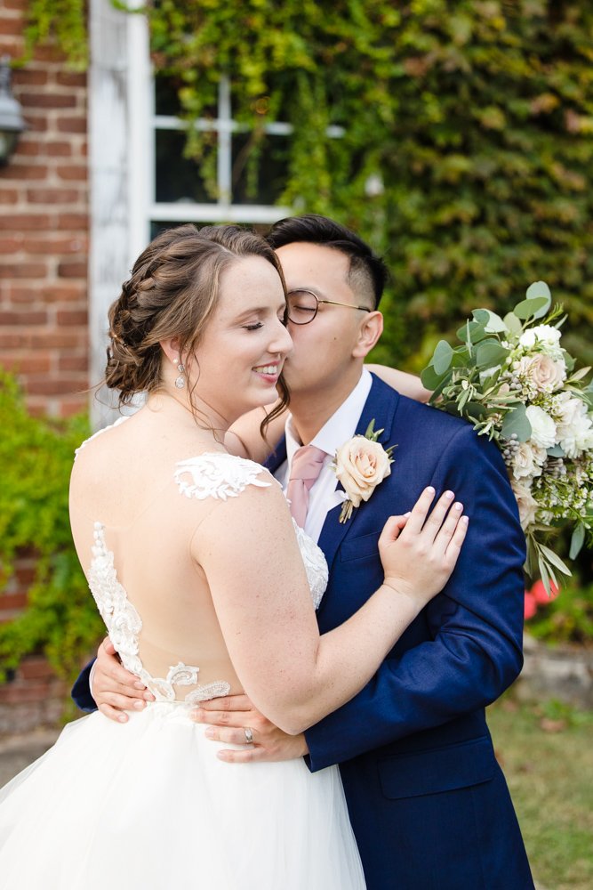 Groom kisses bride on the cheek