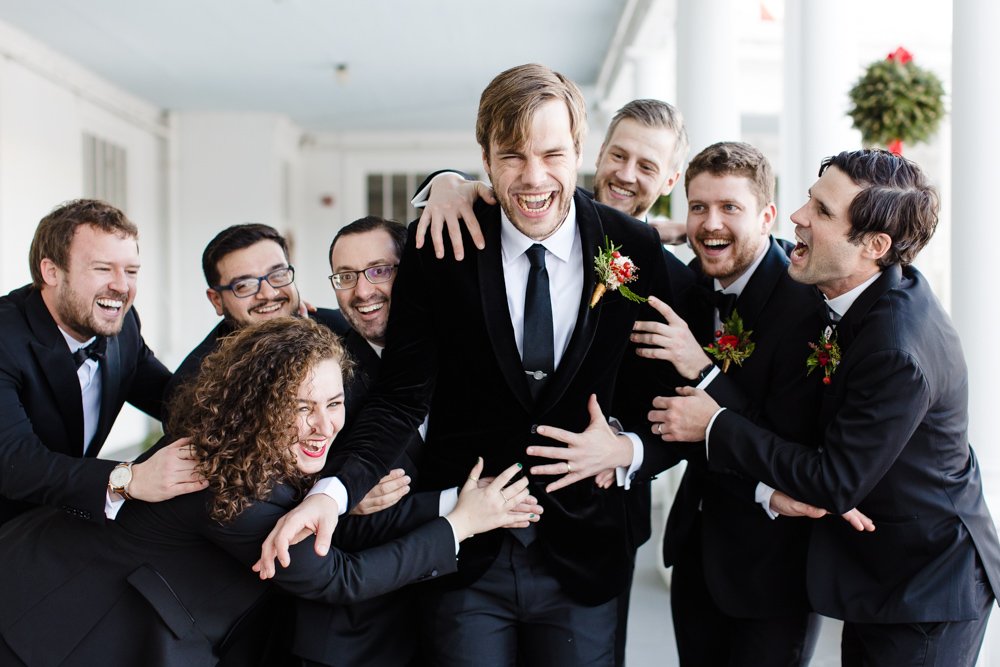 Fun and candid picture of groom with his wedding party