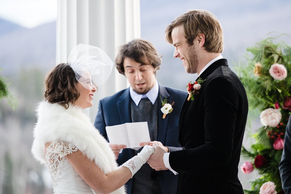 Bride and groom smiling during their wedding ceremony in the White Mountains