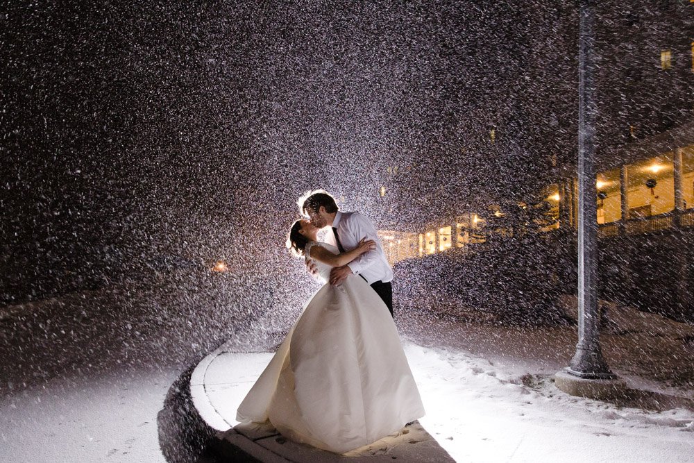 Snowy wedding photo at night at the Omni Mount Washington Resort