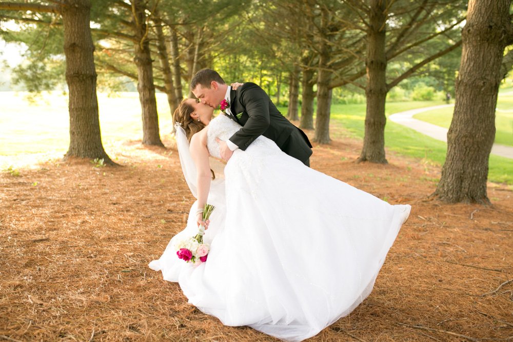 Bride and groom in the evergreen trees at Evergreen Country Club