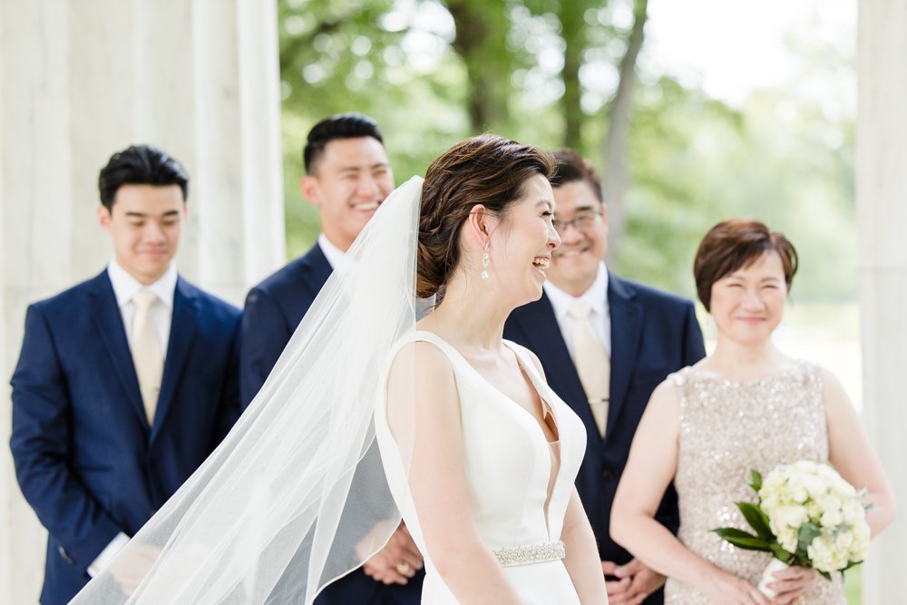 Candid wedding photo of bride laughing during her ceremony at the DC War Memorial