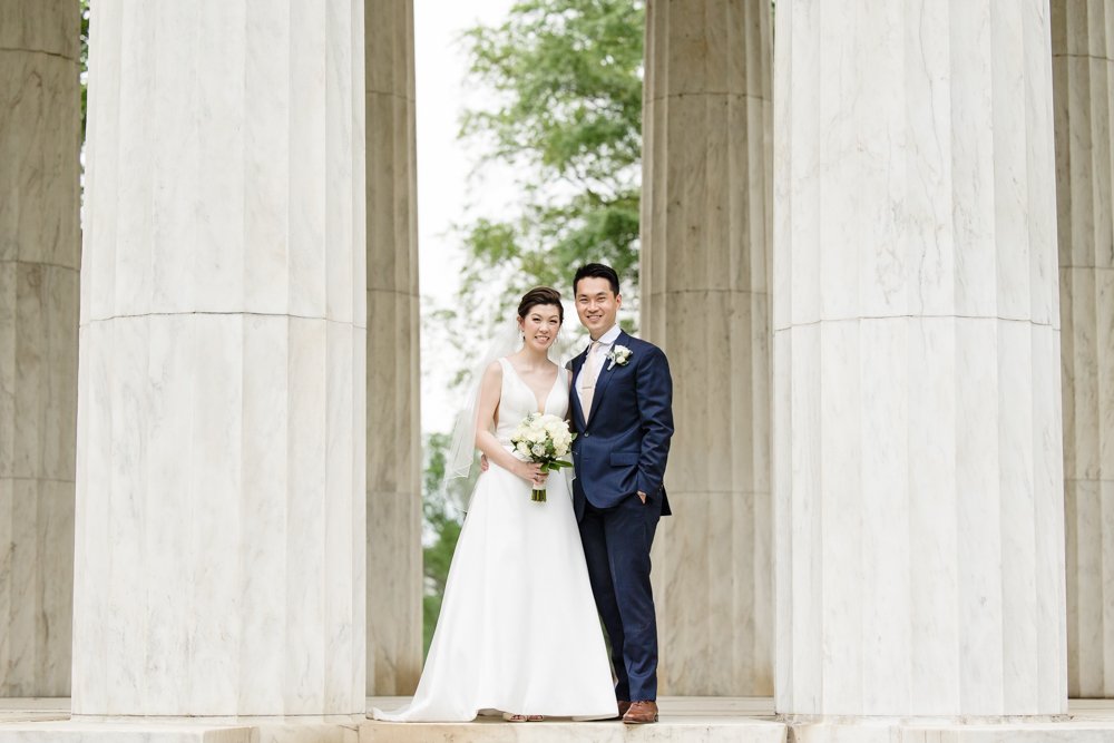 Bride and groom on the steps of the DC War Memorial on the National Mall