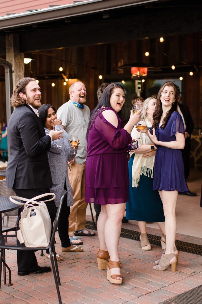 Candid cocktail hour photo of guests laughing