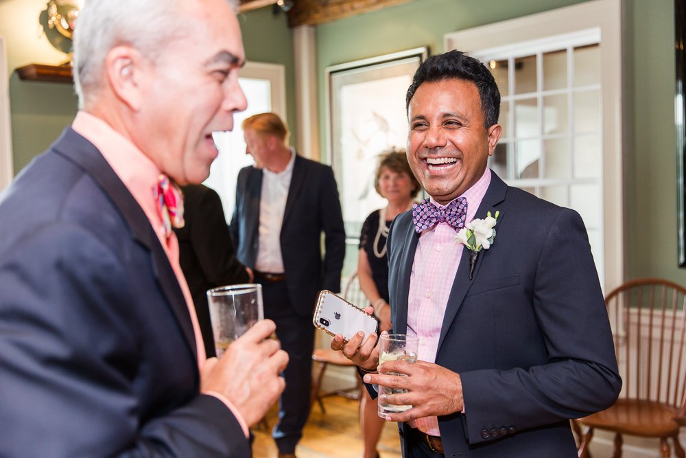 Groom laughing during cocktail hour