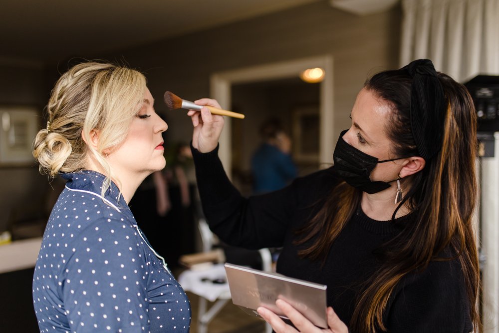 Finn of Blush Away Makeup helping bride get ready for her wedding day