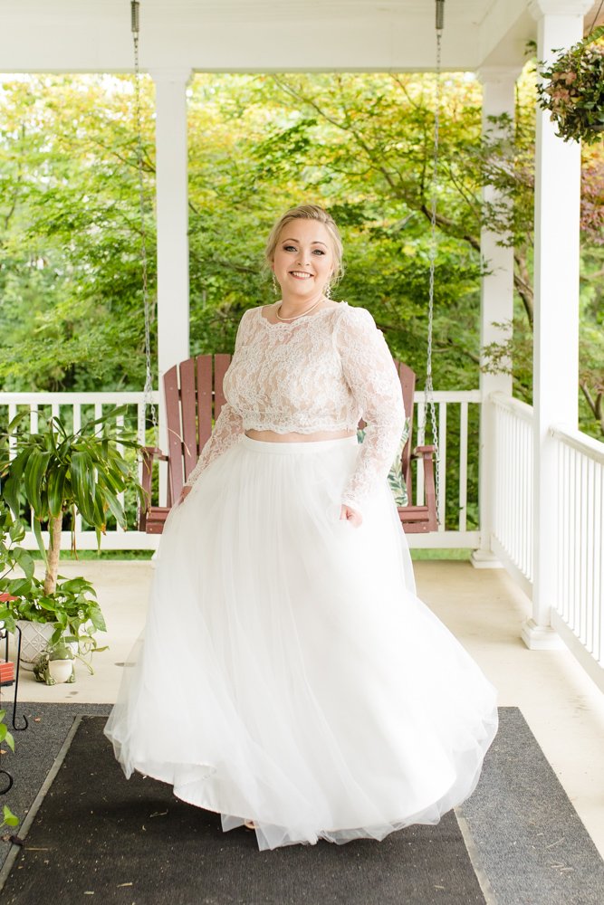 Bride twirling her dress on her front porch
