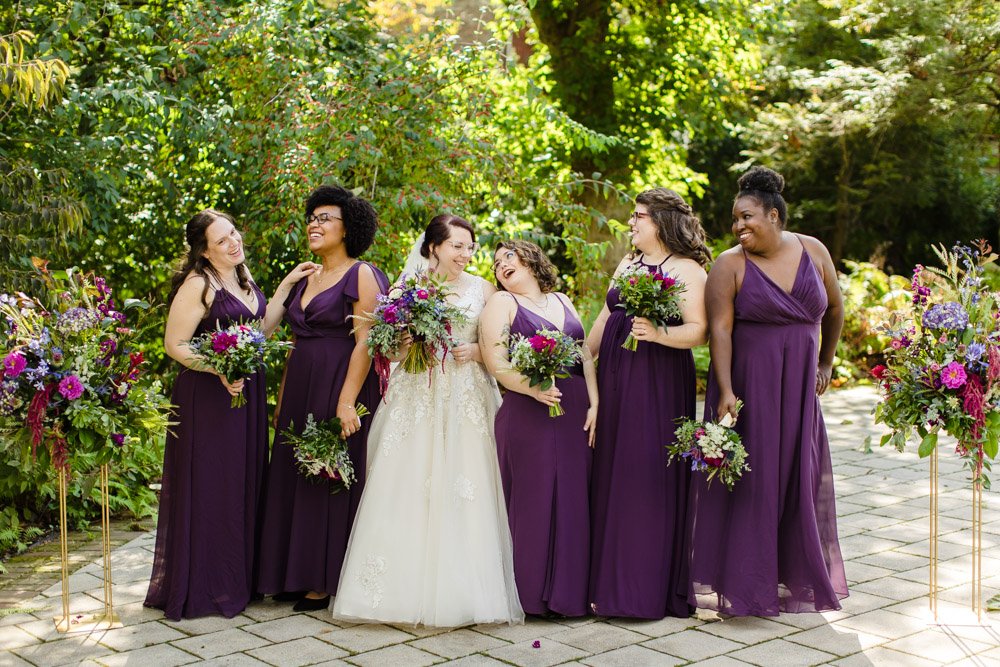 Bride and bridesmaids laughing on wedding day