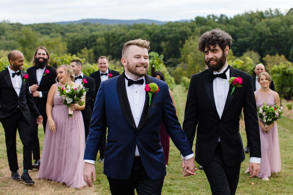 Two grooms with their wedding party