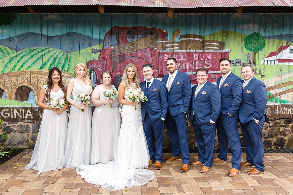 Wedding party poses with the mural