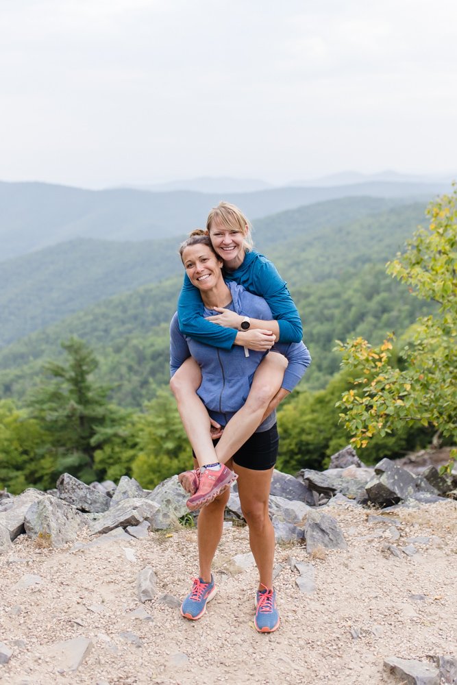Piggy back engagement photo in the mountains