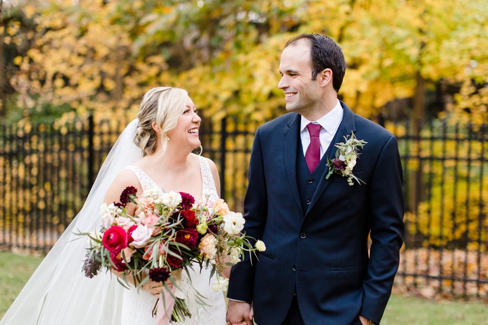 Bride and groom in front of yellow fall leaves at the Omni Shoreham