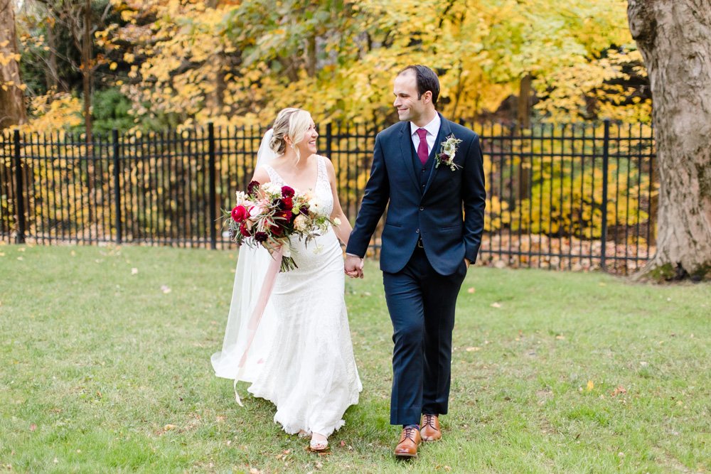 Bride and groom holding hands as they walk