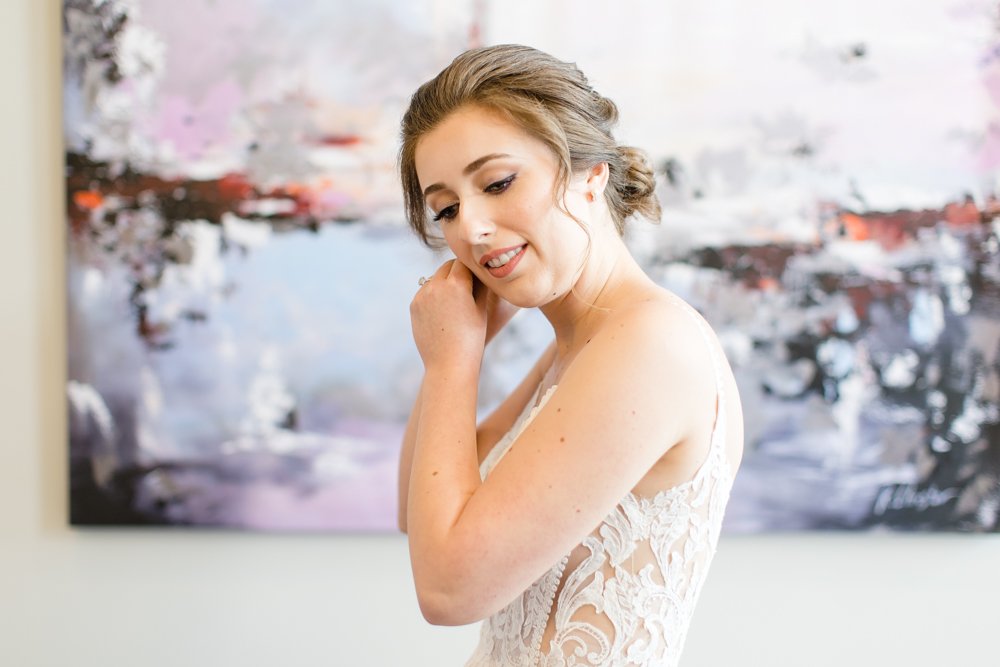 Bride putting in her earrings