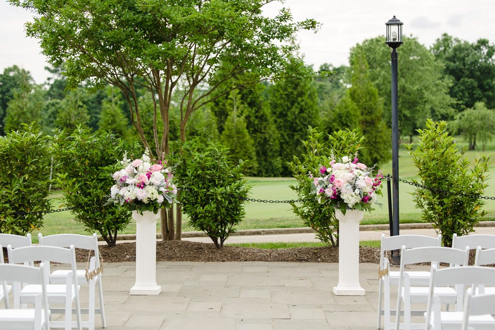 Wedding ceremony floral arrangements on pillars