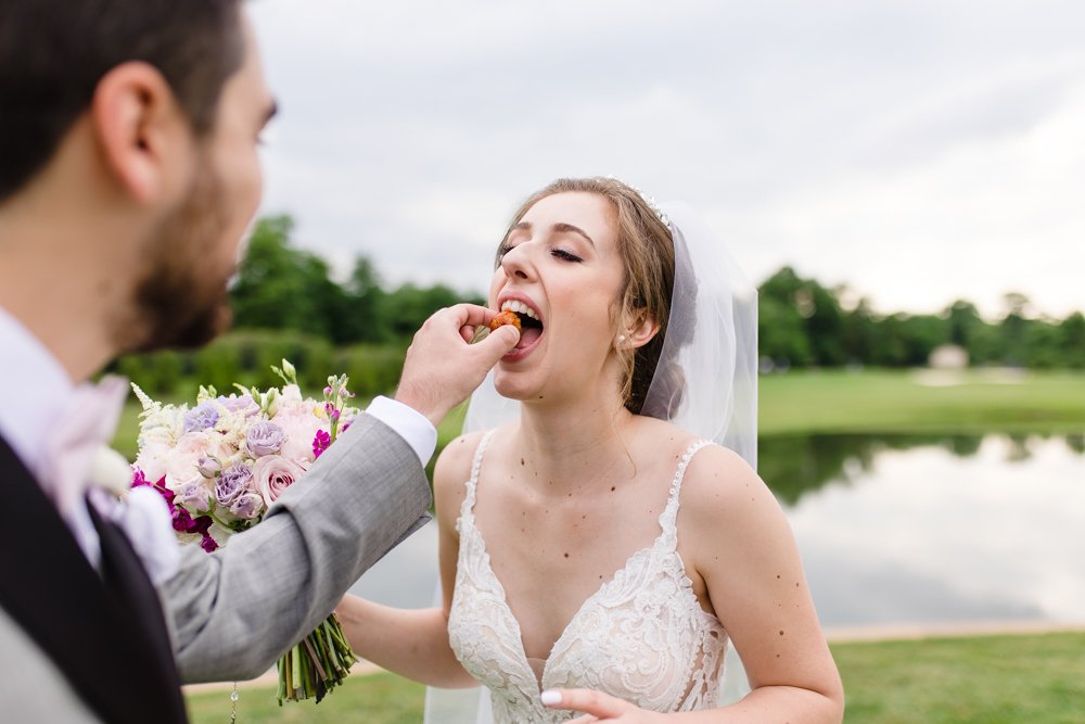 Groom feeding the bride appetizers