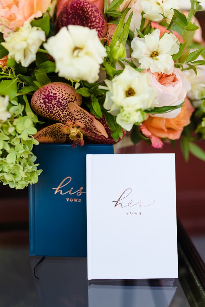 Wedding vow books with bouquet