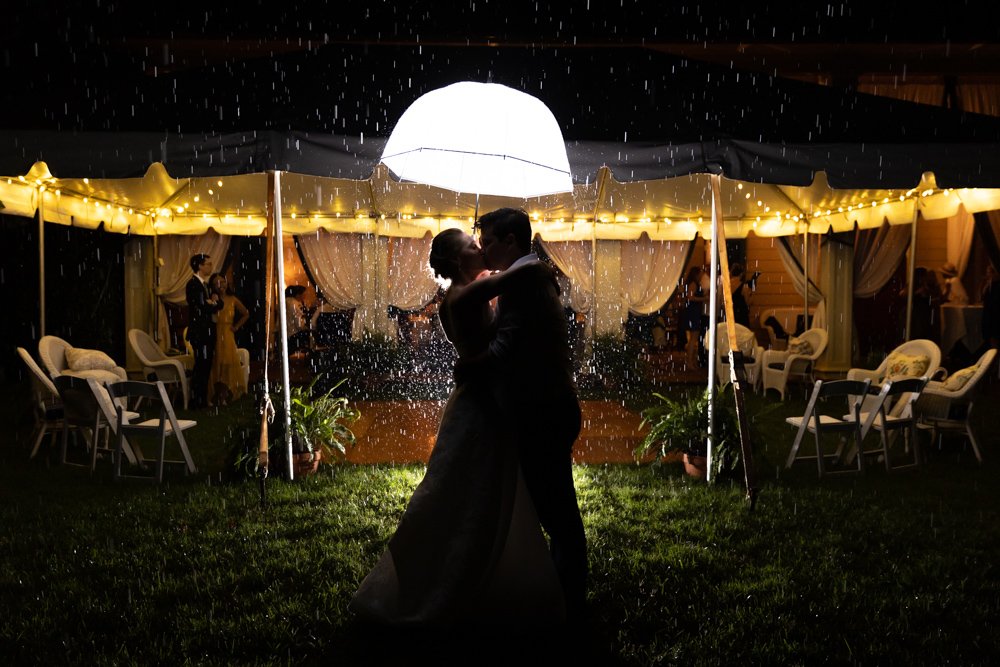Bride and groom kissing in the rain at the Inn at Little Washington