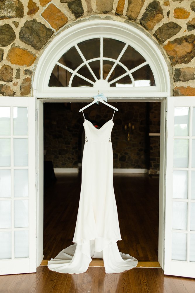 Wedding dress hanging from doorway