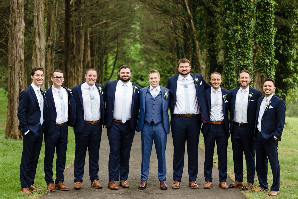 Groom and groomsmen in navy blue suits 
