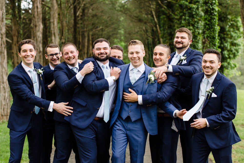  Fun photo of groomsmen hugging the groom 