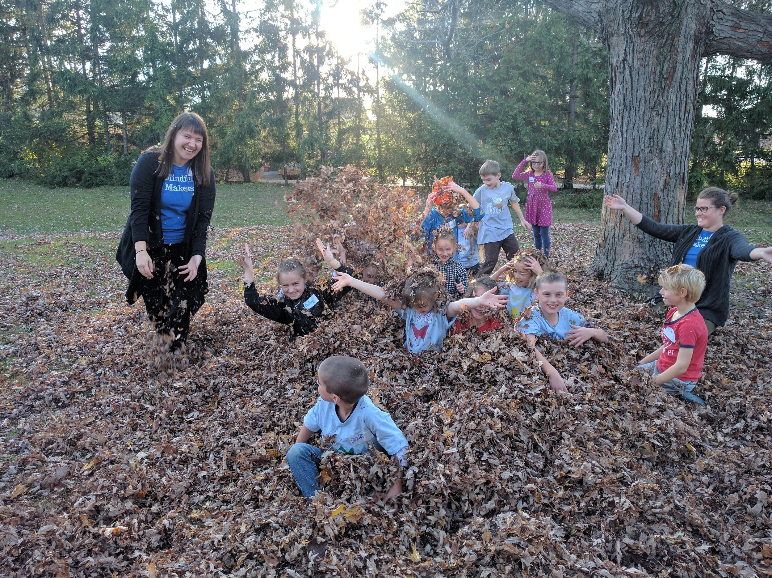 Enjoying the leaves in the backyard at our Nov. PA Day Camp.