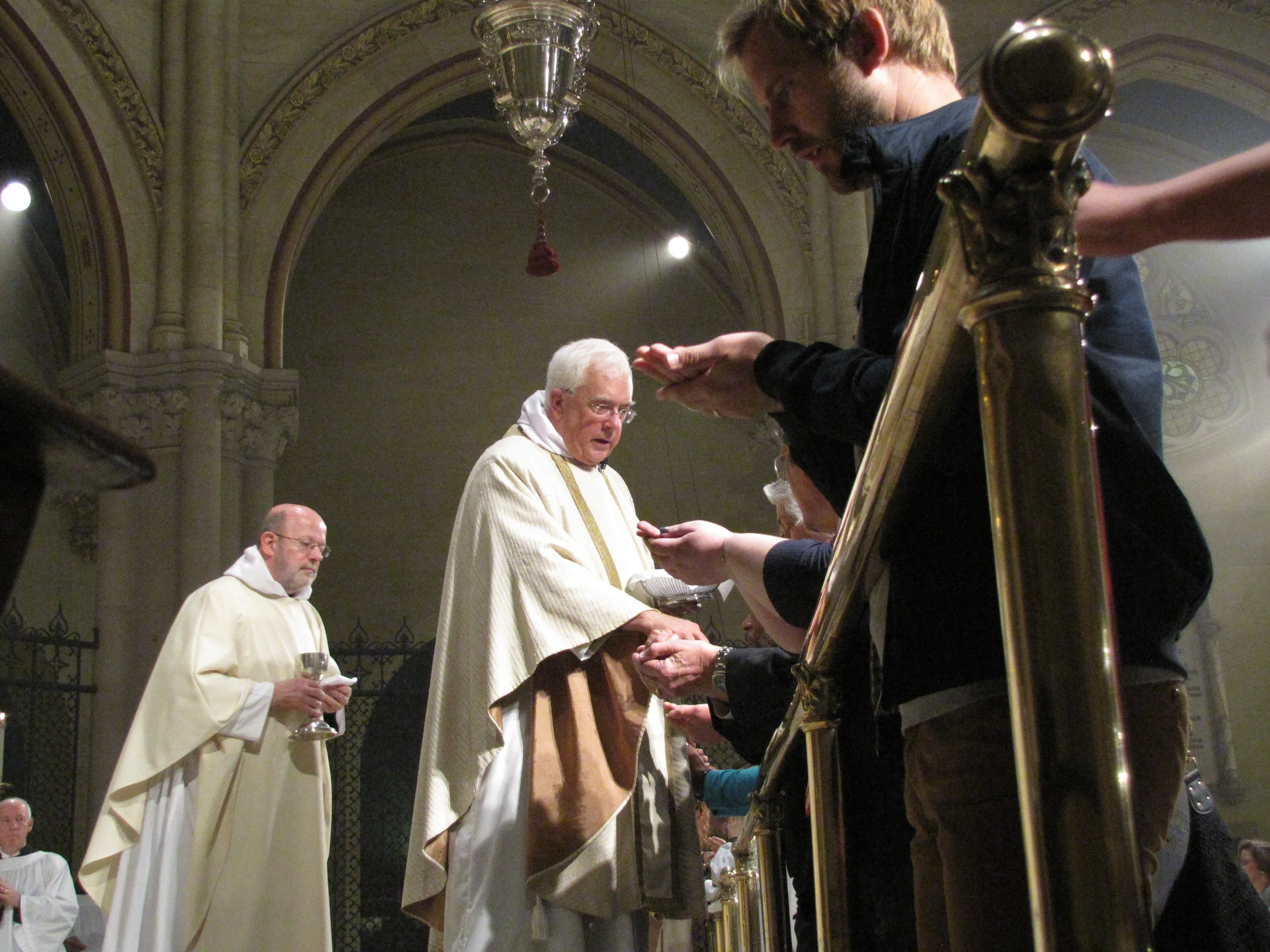 The Reverend James Ross Smith (L) and The Reverend Doctor Peter Powell during Communion at Saint Mary's