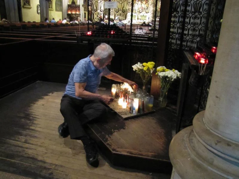  Parishioner Dick Leitsch tending to the candles at the Calvary Shrine