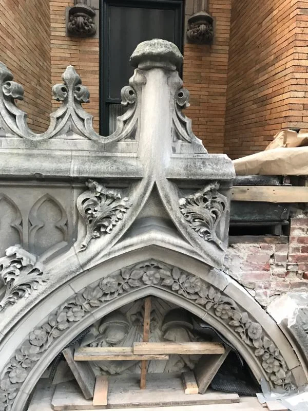 Stones removed for resetting above the West 47th Street doors of the Church