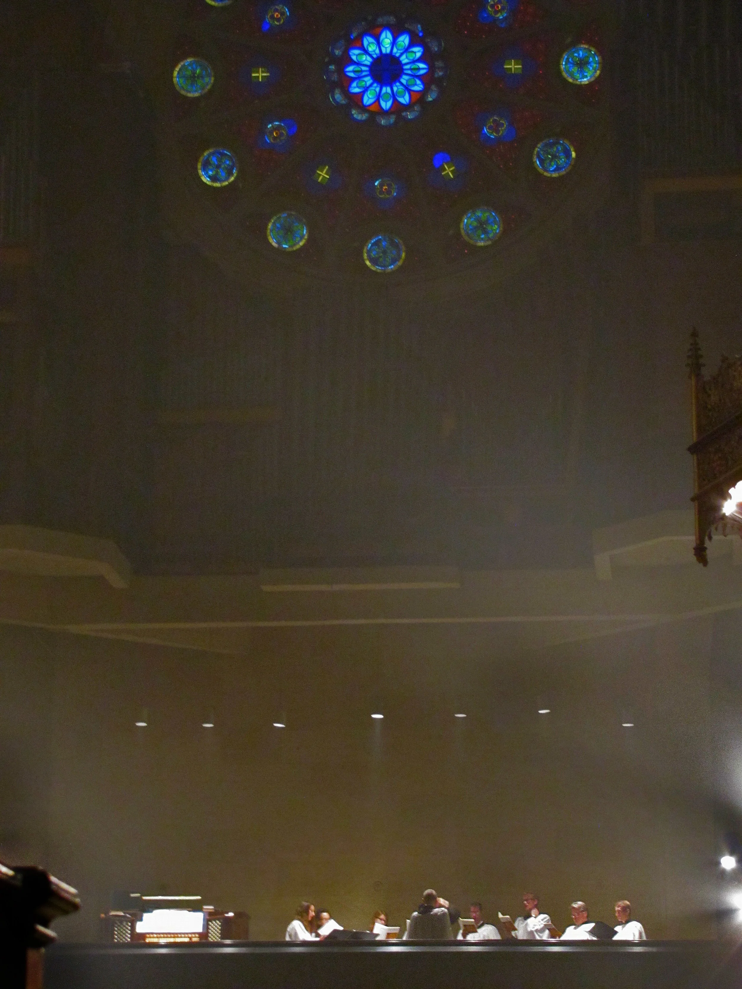 The choir in the choir loft, beneath the Rose Window
