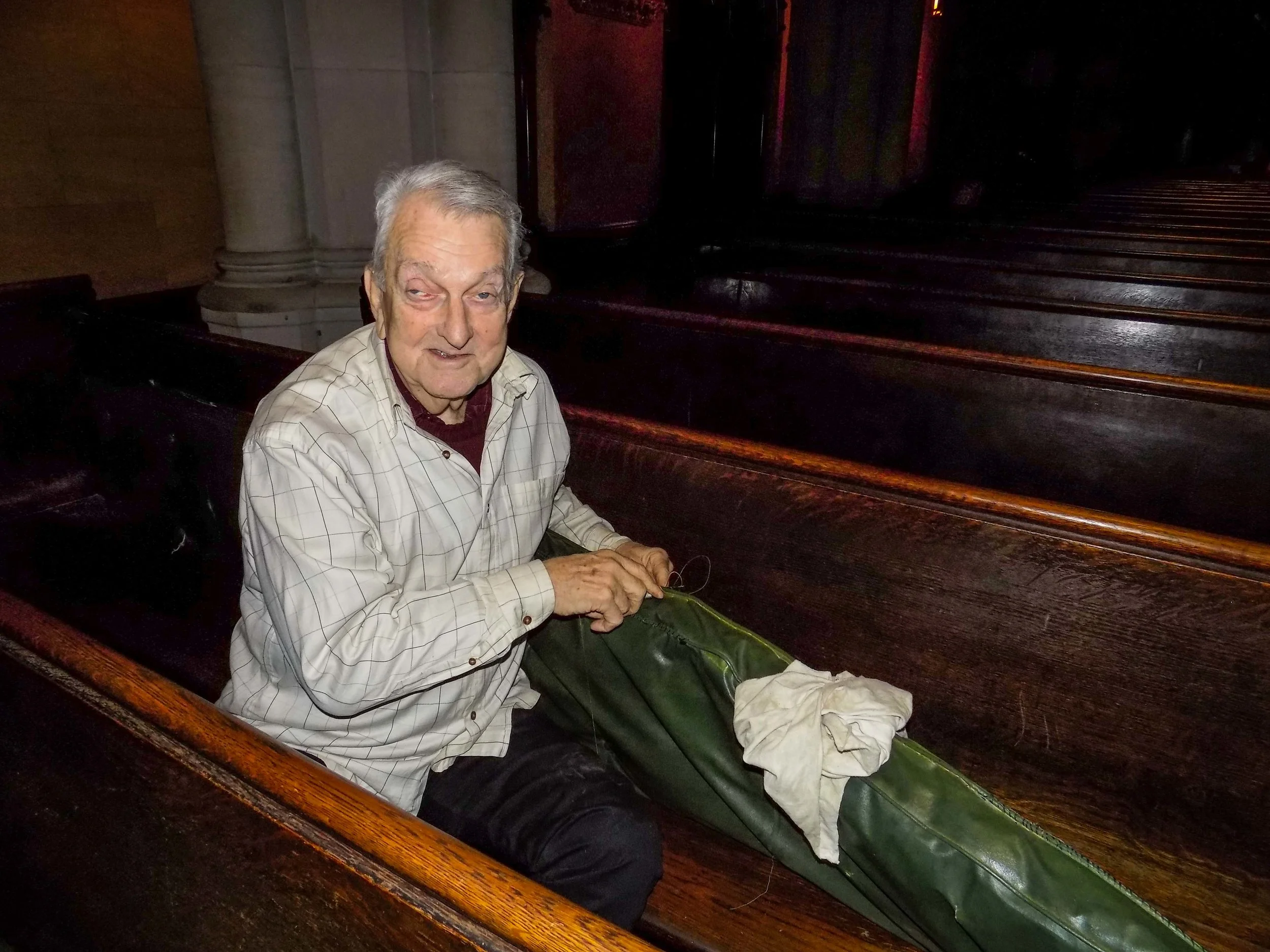 Dick Leitsch repairing pew cushions before Christmas begins. 