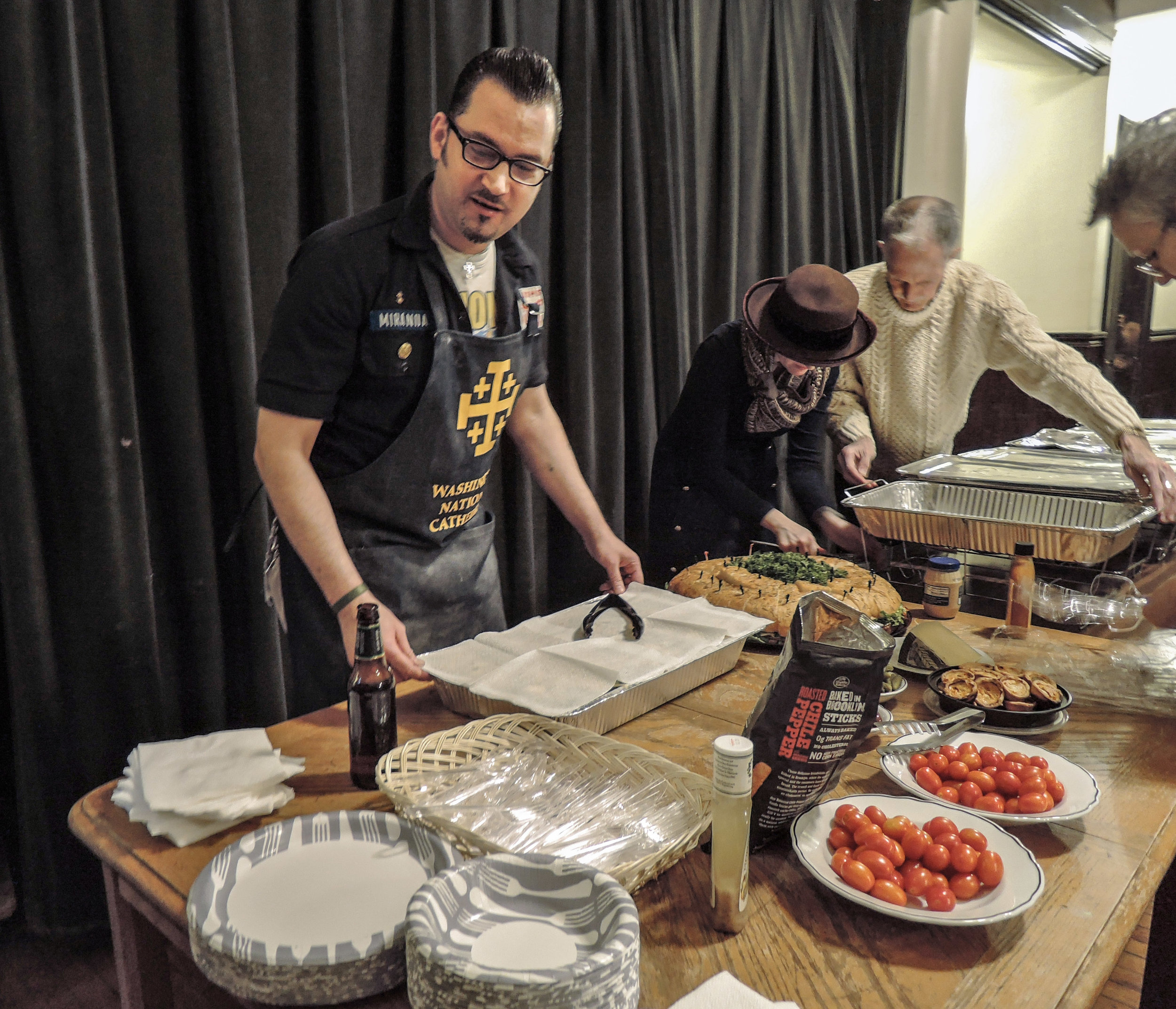 Ric Miranda, Grace Bruni, and John Delves setting up for the Super Bowl Party