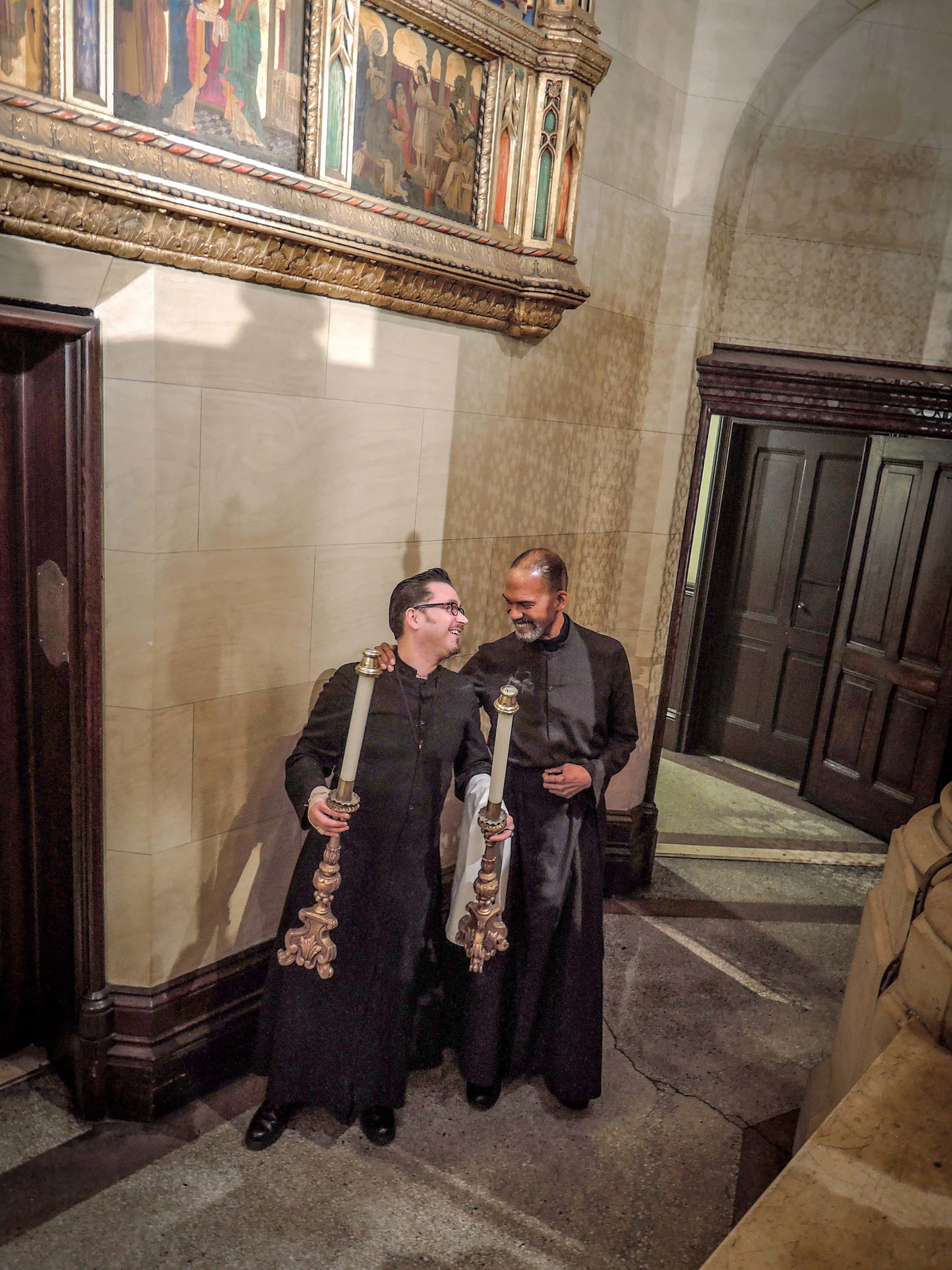 Acolytes Ricardo Mirando (left)&nbsp;and Charles Carson (right)&nbsp;prepare for Solemn Mass last&nbsp;Sunday.