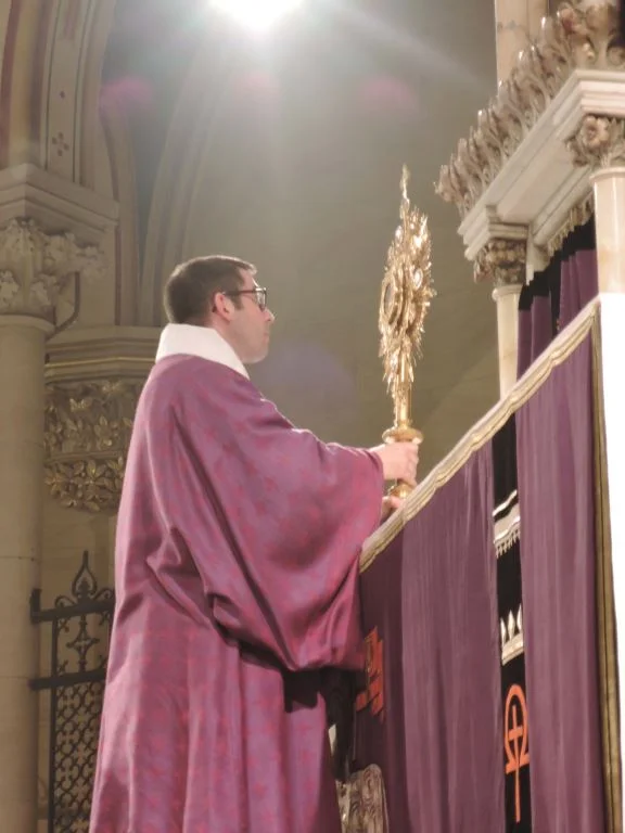 Deacon Matt Jacobson exposes the Host at Benediction.