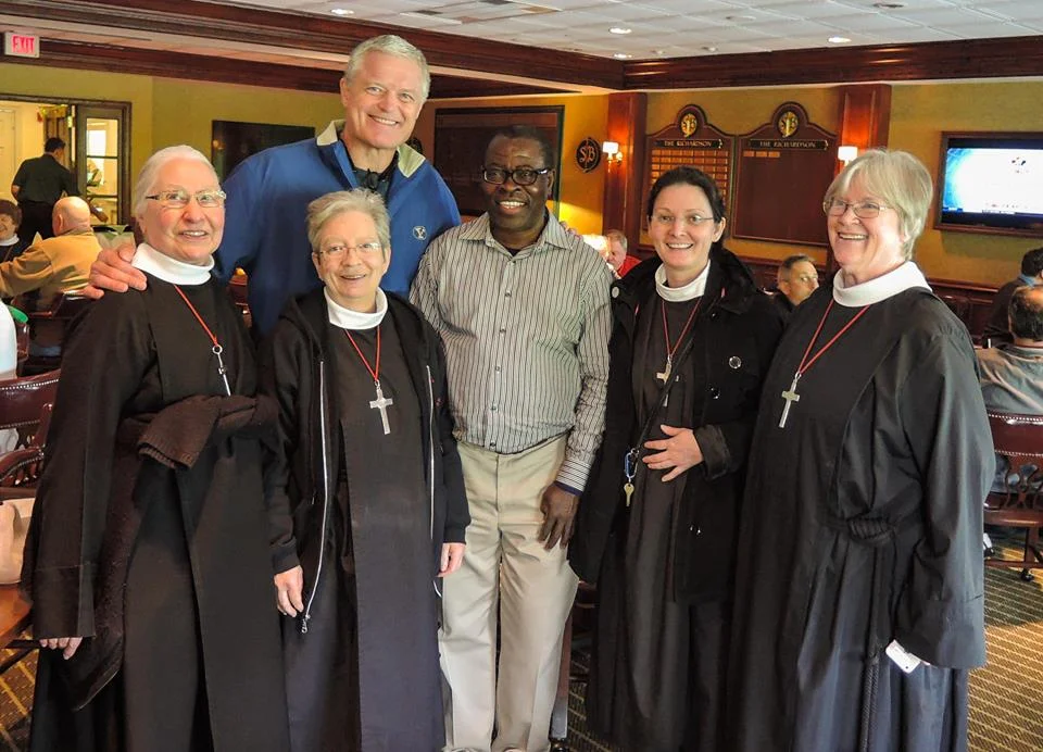 Some of the sisters with former New York Giants player Bart Oates (L) and Father Joseph Ngijoe of the diocese of the Camaroon of the Church of the Province of West Africa. 