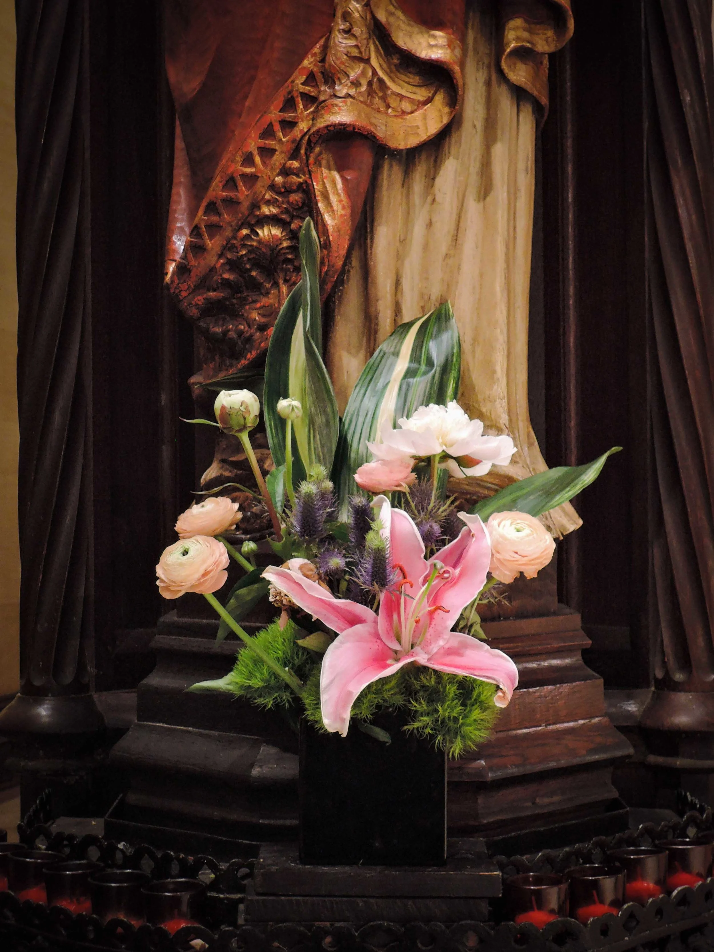 Flowers at the base of the statue of Christ the King at Saint Mary's on Ascension Eve