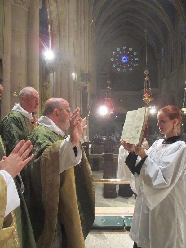 Father Jay Smith sings the collect of the day. 