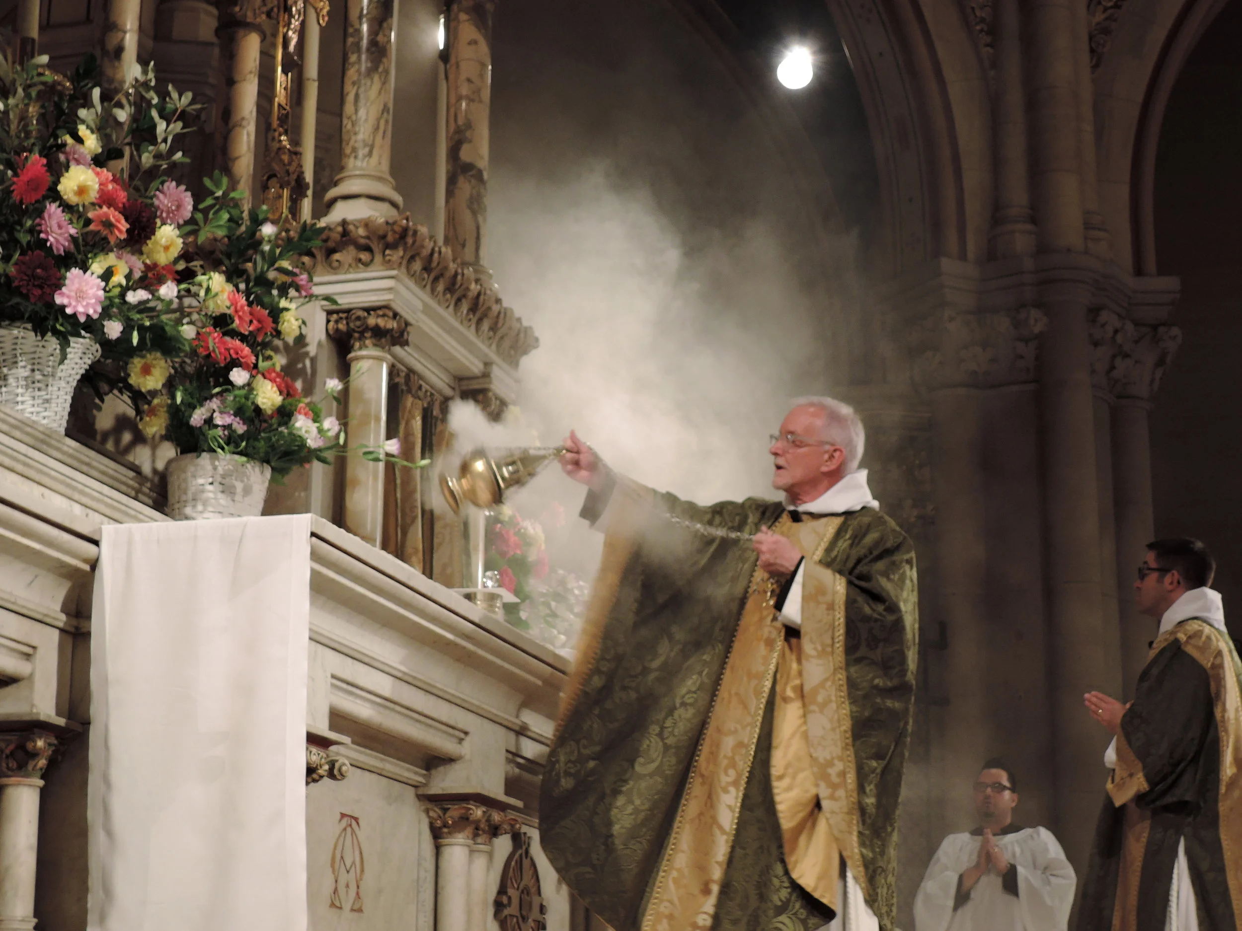 Father Jim Pace censes the altar last Sunday.