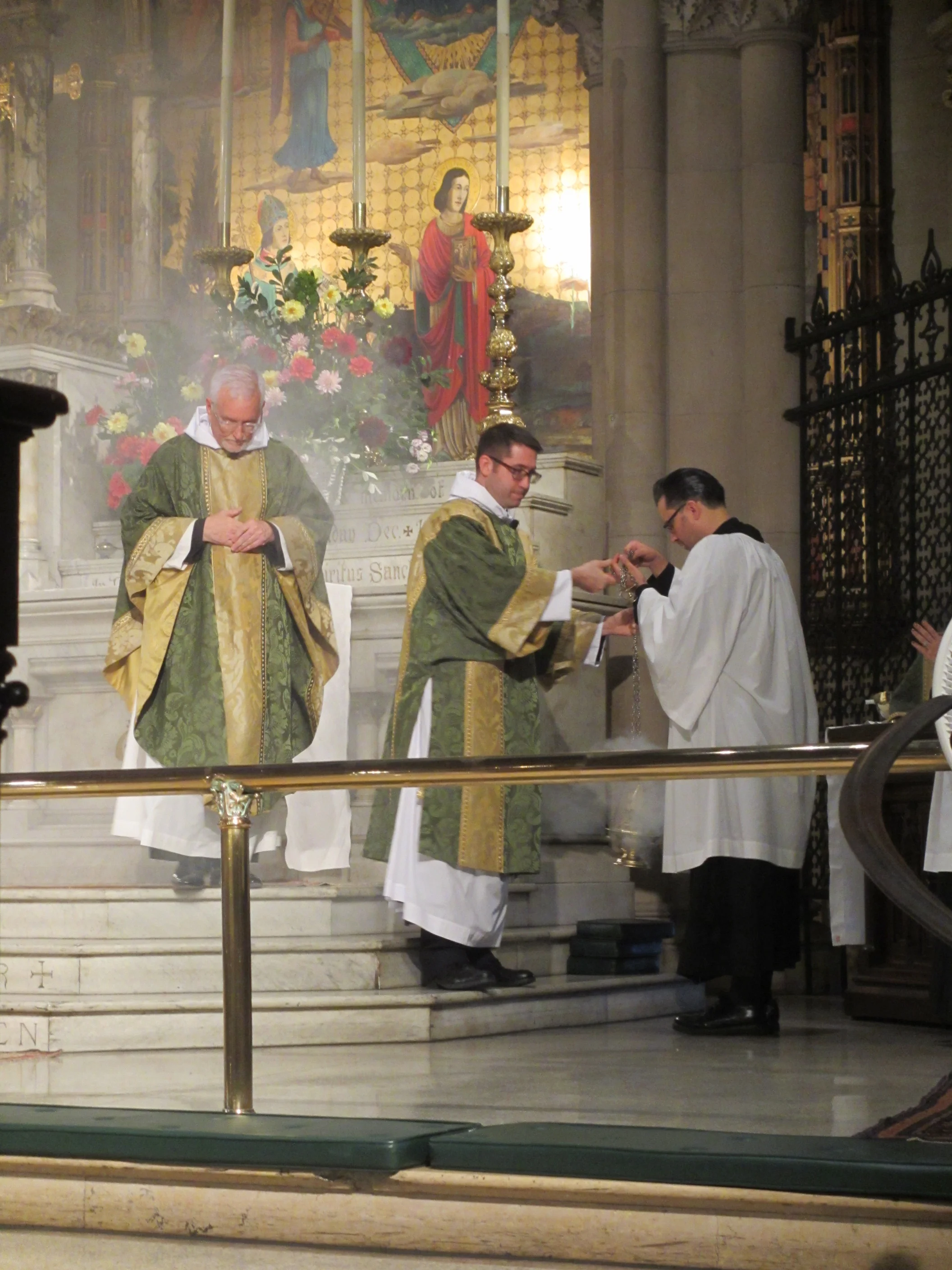 Having censed the altar, Father Pace prepares to chant the Collect of the Day.