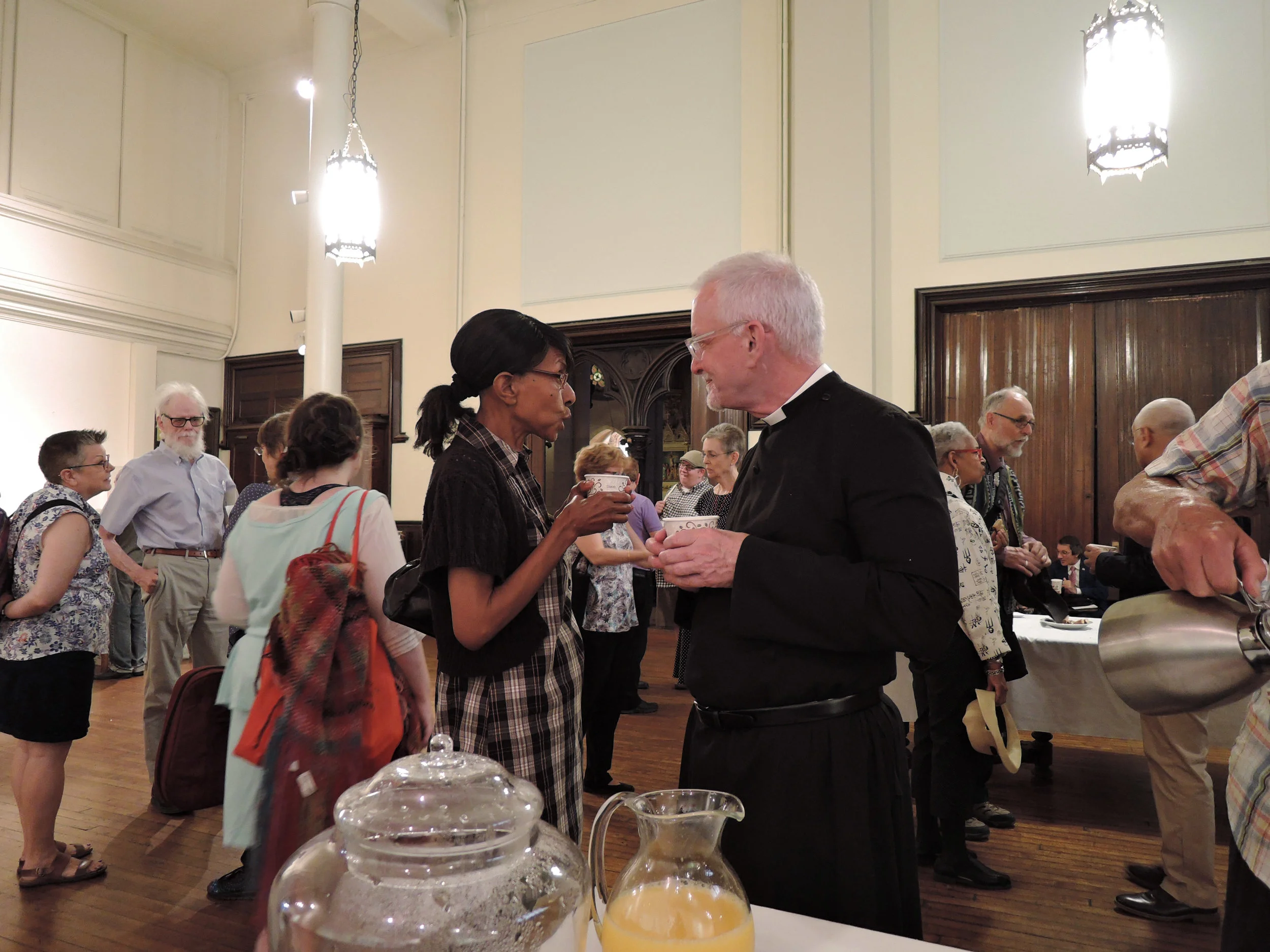 Sharon Stewart chats with Father Pace at Coffee Hour.
