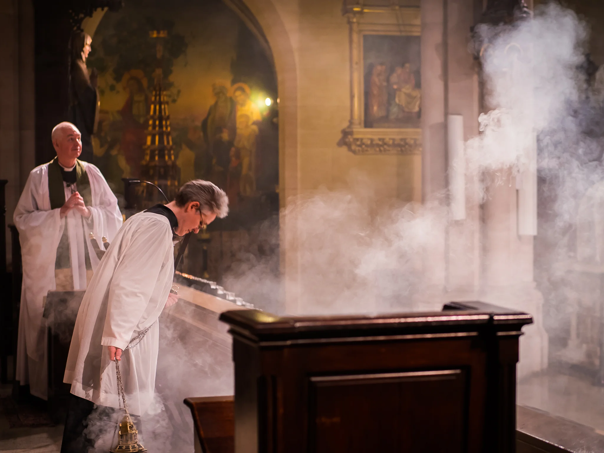Thurifer Marie Rosseels bows to the assembly before and after censing the congregation. Photo by Ricardo Gomez